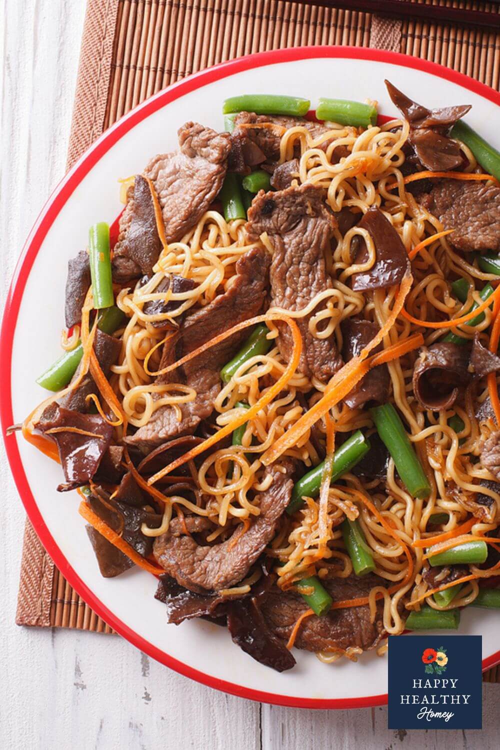 Gluten-Free Lo Mein with rice noodles, green beans and shredded carrots.