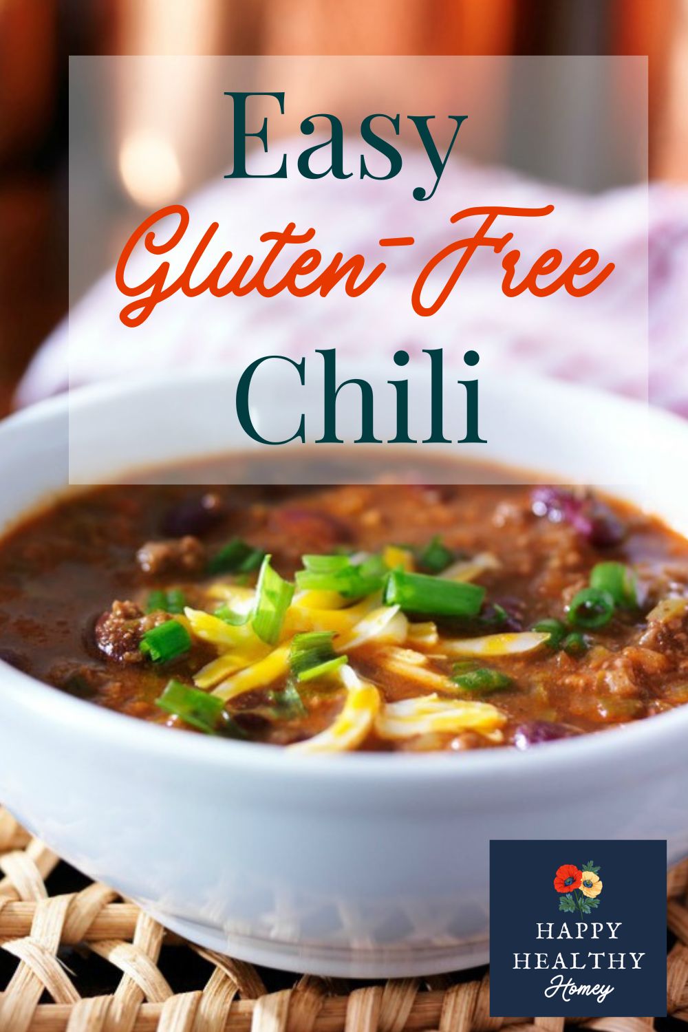 Homemade gluten-free chili in a white bowl, topped with shredded cheese and green onions, with a soft background and a text overlay that reads Easy Gluten-Free Chili.