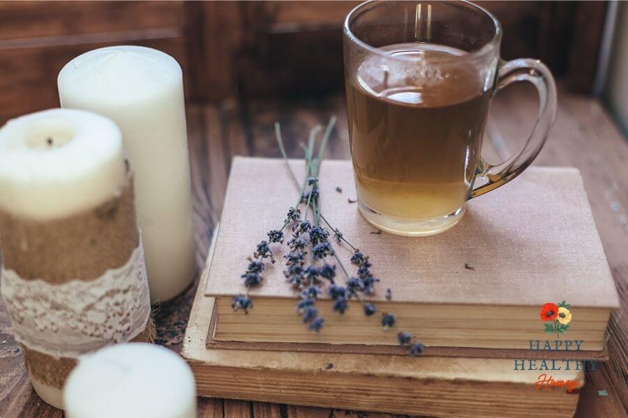 Cozy tea, candles, and books representing rest and slow living after illness