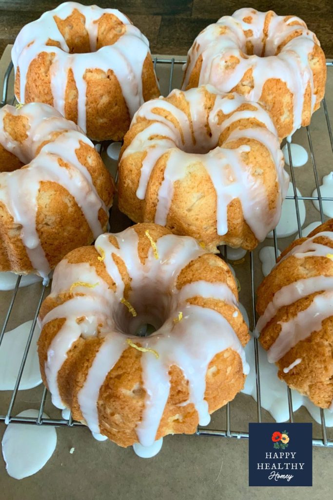 Gluten-free Meyer lemon mini bundt cakes cooling on a wire rack with lemon glaze.