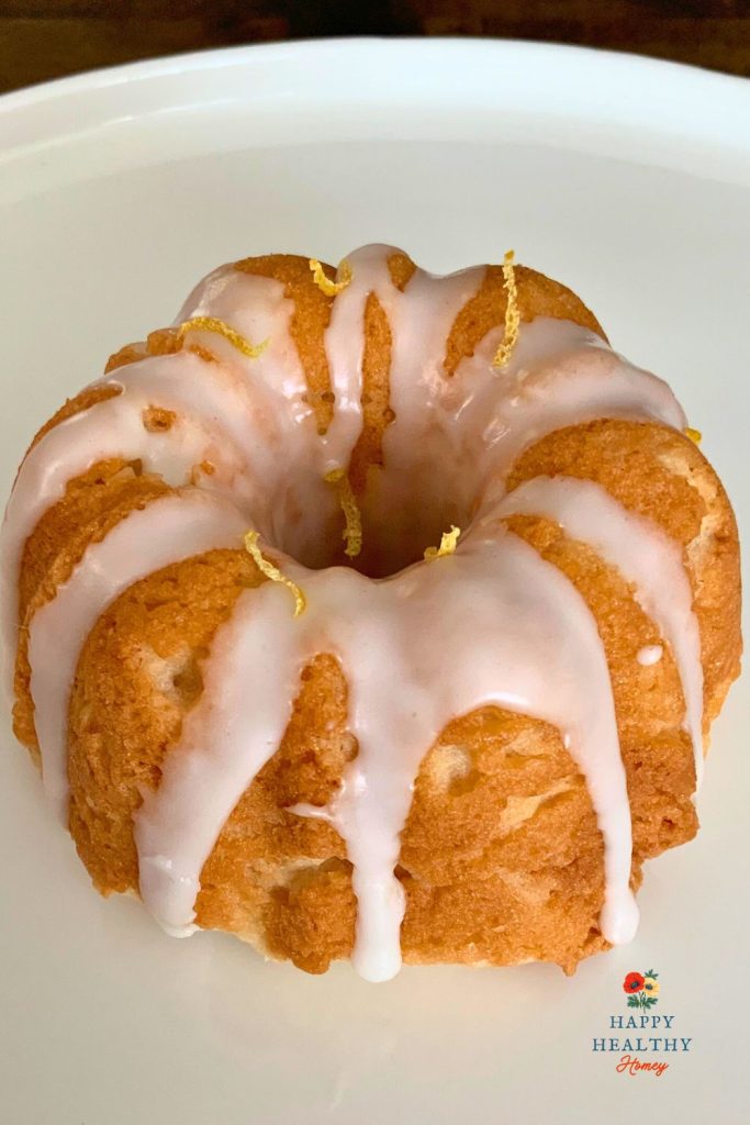 Single gluten-free Meyer lemon mini bundt cake with lemon glaze and lemon zest.