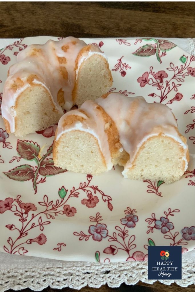 Gluten-free Meyer lemon mini bundt cake with lemon glaze sliced on a floral plate.