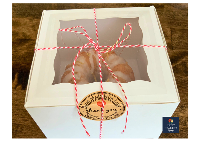 Gluten-free Meyer lemon mini bundt cakes packaged in a bakery gift box with baker&rsquo;s twine.