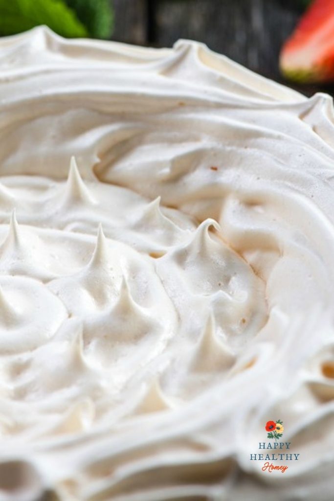 Baked meringue pie crust with golden brown peaks in center of crust.
